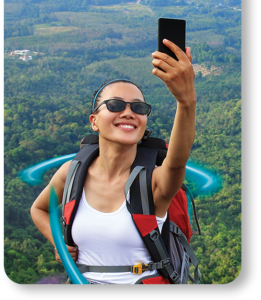 Woman in white tank top holding black smartphone